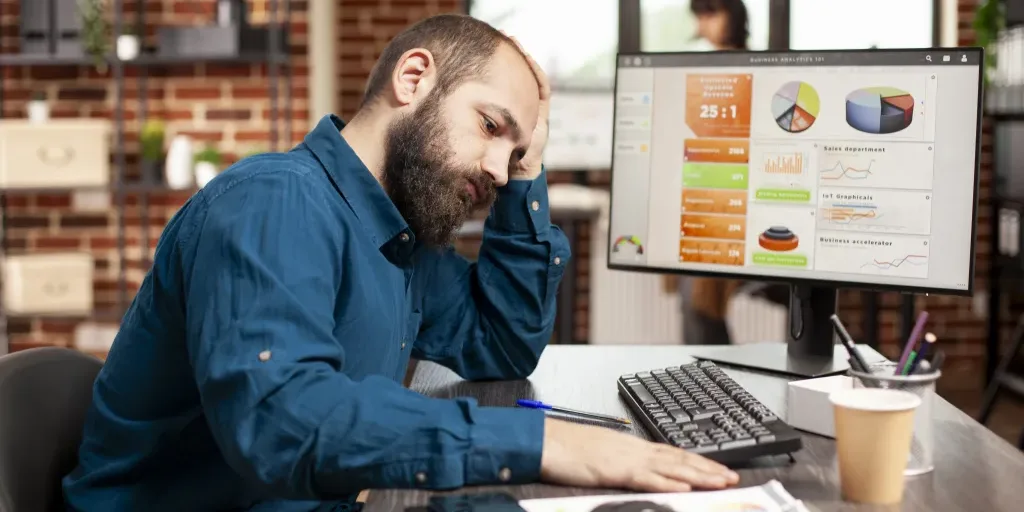 Exhausted businessman holds his forehead crisis management