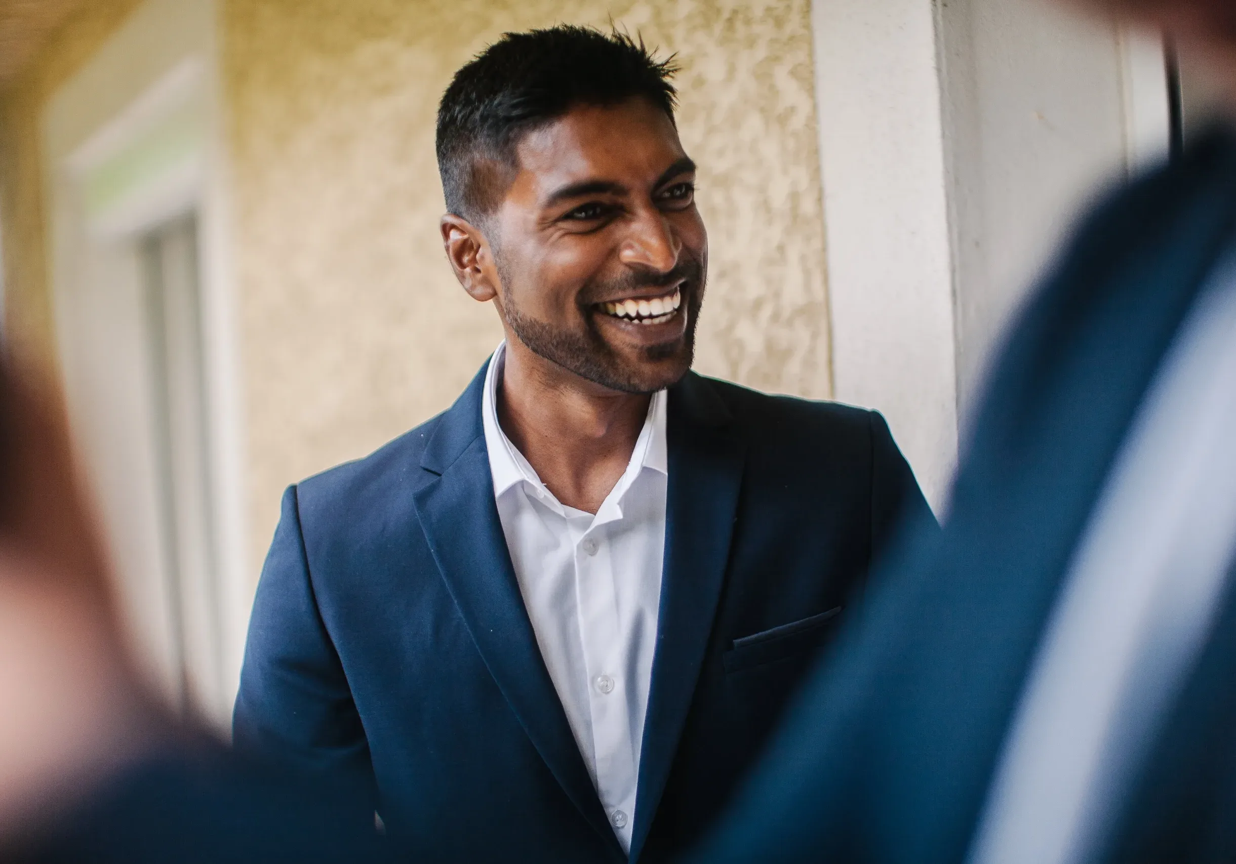 handsome man smiling wearing a suit in a conversat 2025 01 09 05 33 16 utc